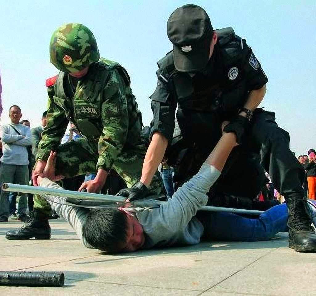 Policiais fazem treino ostensivo na estação de trem de Yiwu, Zhejiang